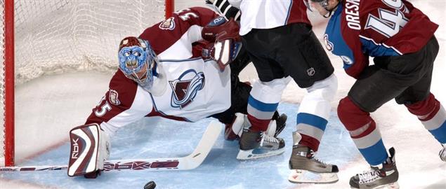 Avalanche rookie goalie Tyler Weiman slides to make a save in traffic during scrimmage.