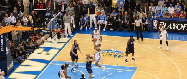 Denver Nuggets' Dahntay Jones attempts jump shot over the Dallas Mavericks' Dirk Nowitzki.